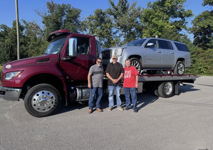 Delivery day: maroon International MV rollback with a GMC Yukon loaded