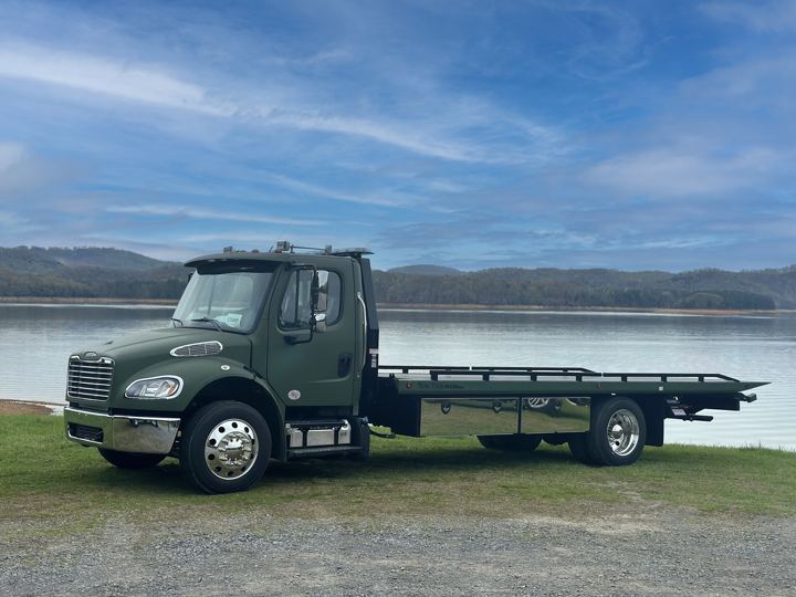 Green Freightliner by the lake