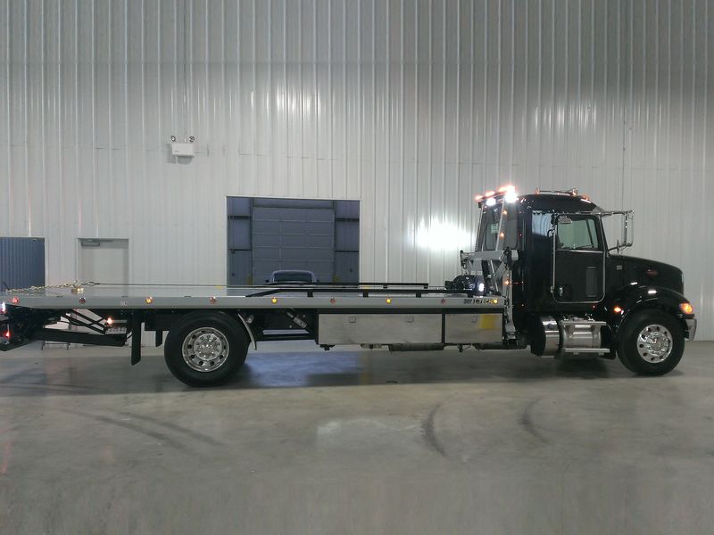 16 Series rollback on a black Peterbilt